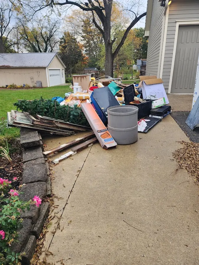Dumpster being loaded with debris for Demolition Dumpster Rental in Franklin